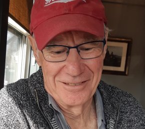 Picture of Clive Doucet writing in his home office in Cape Breton, Nova Scotia