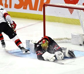 Ottawa Senators goalie Joonas Korpisalo stretches to make a save vs. NJ Devils, Dec. 29, 2023 