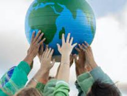 picture of a globe being held up by young people with their hands meeting together
