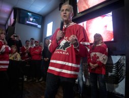 Picture of Canadian PM Mark Carney speaking, while wearing a Team Canada hockey sweater