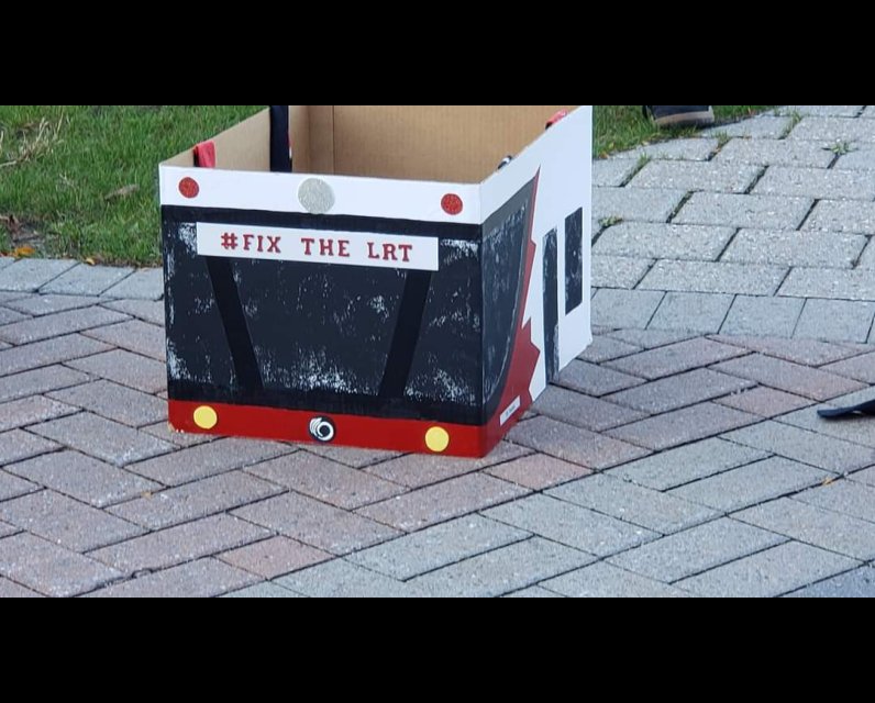 Box that looks like the front of an OC Transpo bus with "Fix The LRT" written on it