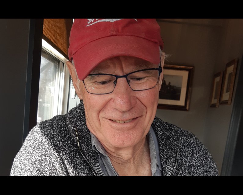 Picture of Clive Doucet writing in his home office in Cape Breton, Nova Scotia