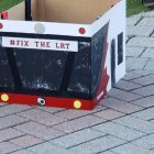 Box that looks like the front of an OC Transpo bus with "Fix The LRT" written on it