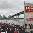 Composite image of the Gordy Howe bridge and a Trump 2026 sign. 