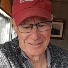 Picture of Clive Doucet writing in his home office in Cape Breton, Nova Scotia