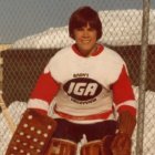 A Canadian goalie in Davos Mark Carney wearing goalie equipment in his youth